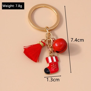 Detail of Christmas keychain with red tassel, bell, and snowflake sock pendant