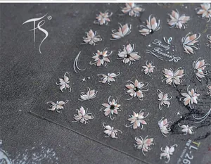 Detail of 3D embossed floral nail stickers with glitter butterfly and pearl accents