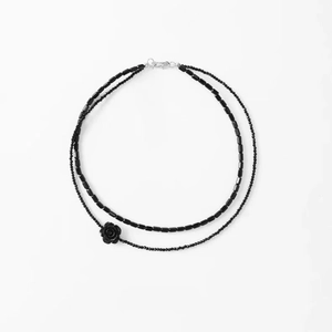 Double-layered black crystal bead necklace with a 3D rose pendant on a white background