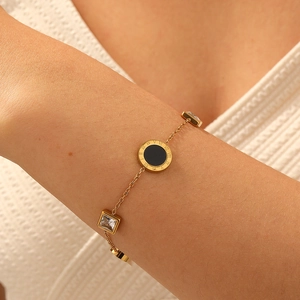 Elegant gold chain bracelet with Roman numerals pendant and square zircon accents on wrist