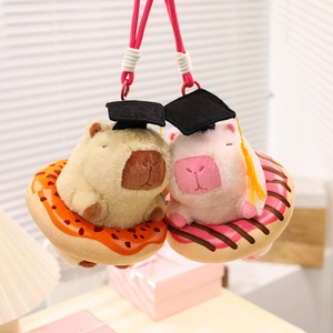 Cute capybara plush keychain set with graduation caps sitting in colorful donuts