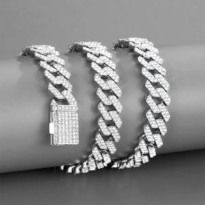 Macro shot of 12mm silver Cuban link chain with pave-set rhinestones and box clasp