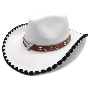 Close-up of white felt cowboy hat featuring bull head metal buckle and braided edge detail