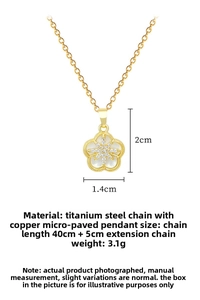 Macro detail of gold flower starburst pendant with dimensions 2x1.4cm on titanium chain