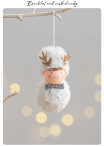 Close-up of a white plush reindeer ornament with silver sequin bow and festive details