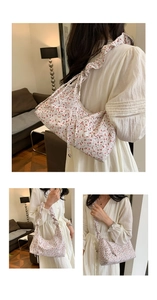 Detail of floral tote bag showing the ruffled pleated shoulder strap and fabric texture