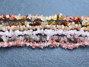 Close-up of natural irregular chip stone beads in various colors for DIY jewelry making