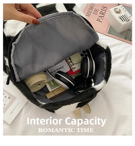 Detailed interior view of plush cow print backpack showing spacious storage capacity