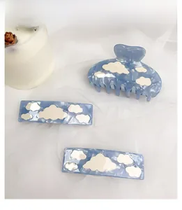 Blue cloud pattern hair claw set with rectangular clips on white mesh background