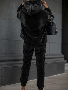 Back view of a black velour tracksuit featuring an oversized hoodie and joggers
