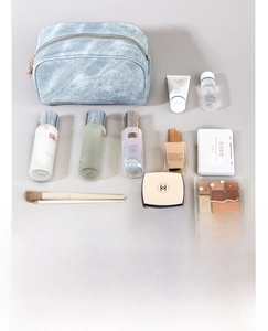 Macro detail of the large capacity compartment and durable denim texture of the makeup bag