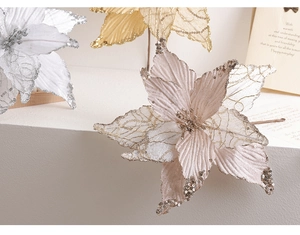 Macro detail of artificial poinsettia with sparkling glitter edges and fabric petals