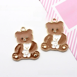 Detail of brown cartoon bear enamel charms with golden metal edges for DIY jewelry