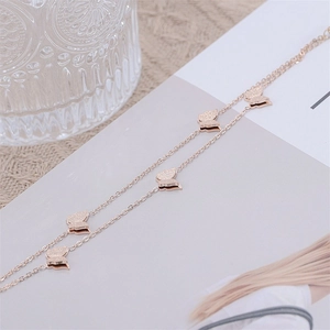 Close-up of rose gold double-layered butterfly bracelet with frosted textured pendants