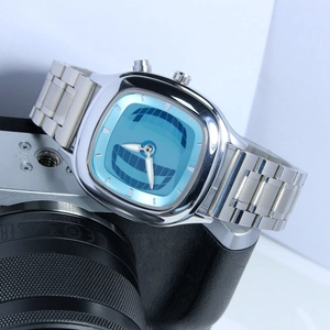 Close-up of a vintage square alloy quartz watch with a light blue dial and steel band