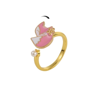 Detail of a rotating fox ring with pink enamel flowers and a white pearl accent