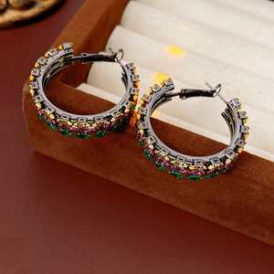 Detail view of vintage multi-row hoop earrings with colorful zircon stones in a velvet box