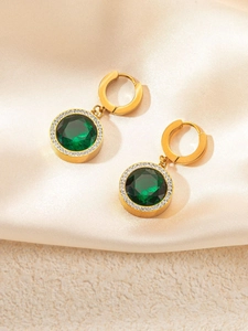 Detail of gold hoops with emerald green stone and sparkling crystal halo setting