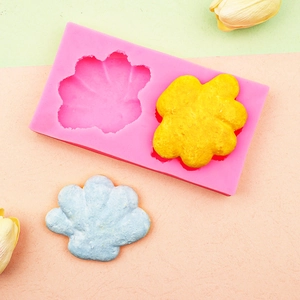 Pink silicone mold for DIY flower soaps and candles with two petal-shaped cavities