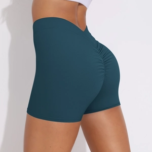Detail showing high-waisted scrunch butt design on dark cyan stretchy yoga shorts