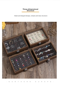Top view of walnut jewelry boxes with glass lids showing rings and necklaces inside