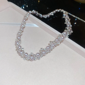 Macro shot of pearl and zircon necklace displayed in a premium velvet jewelry box