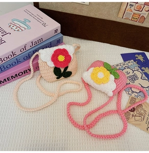 Close-up of cute handmade crochet mini shoulder bags with floral decor in cozy aesthetic setup.