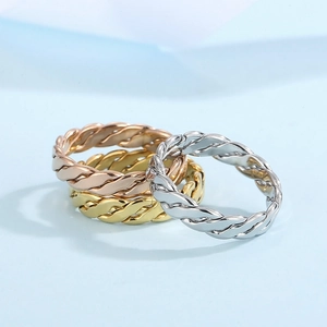 Detail of twisted cable chain rings in gold, silver, and rose gold stainless steel set