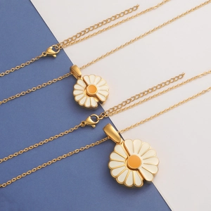 Gold-tone titanium steel daisy necklaces with enamel flower pendants on blue-white background