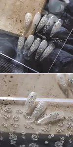 Macro detail of 3D embossed rose nail stickers with pearl white cat-eye finish