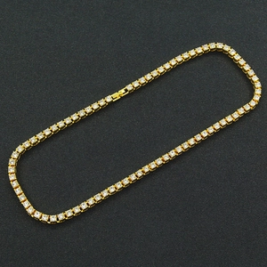 Close-up of a gold-toned hip hop tennis necklace with sparkling round rhinestones