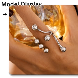 Detailed close-up of a 18K gold-plated titanium steel branch ring with small bead accents