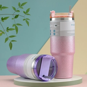 Detail of 30oz vacuum insulated tumblers with glitter finish in pink and purple colors