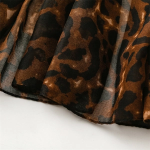 Macro detail of soft leopard print chiffon fabric texture with high-quality finished edges