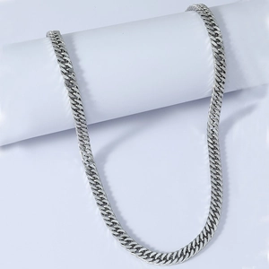 Detailed close-up of a silver Cuban link chain necklace with polished metallic finish