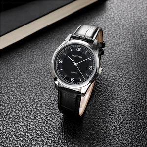 Detailed close-up of a silver quartz watch with a large black dial and leather strap