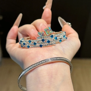 Three-layer silver bangle featuring sparkling blue stones and white zircon crystals