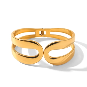 Detailed macro view of 18k gold-plated stainless steel spring cuff with hollow design