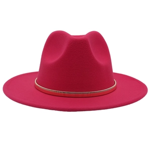 Detail of the golden metal chain accent on a vibrant magenta wide-brim wool fedora hat