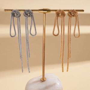 Retro knotted chain tassel earrings in gold and silver finish on display stand