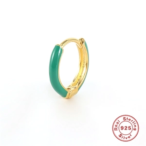 Detailed macro of S925 sterling silver gold earring with green enamel and hallmark