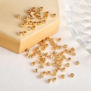Macro shot of 14k gold-filled round spacer beads with spiral textured finish for DIY jewelry