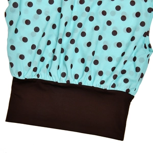 Close-up of light blue chiffon fabric with dark brown polka dots and elastic waist detail