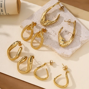 Detailed view of four pairs of 18k gold plated twisted and geometric hoop earrings set