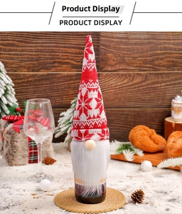 Close-up of knitted gnome wine bottle cover with snowflake pattern and white faux fur beard