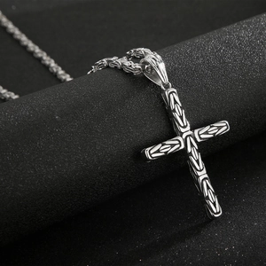 Macro shot of silver Byzantine chain with gothic cross pendant in titanium steel