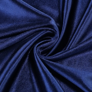 Macro shot of silky dark blue fabric with high gloss and smooth pleated texture