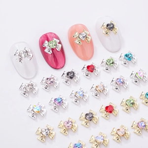 Detailed view of alloy bowknot nail charms with multi-colored heart-shaped rhinestones