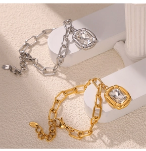 Detail of gold and silver steel chain bracelets with square crystal pendant stones
