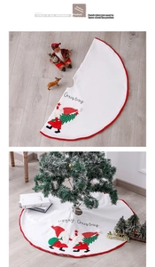 Detail of white plush Christmas tree skirt with Merry Christmas text and Santa motif
